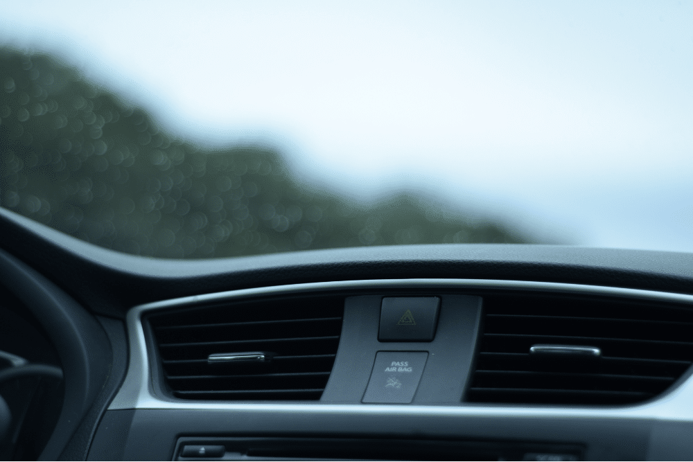 a/c repair, auto repair in The Woodlands, TX at Repair One Tire & Auto. Interior dashboard view focusing on central air vents and hazard light button in a modern vehicle.